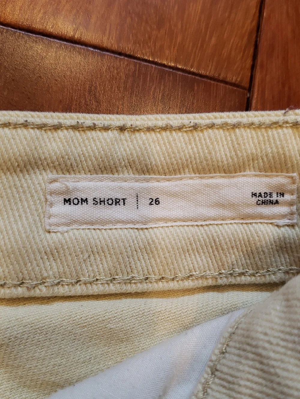 Pac Sun Women's size 26 Mom Short. Light yellow destructed denim jean